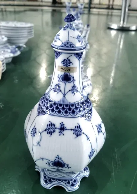 A blue and white porcelain vessel carrying an inventory label, part of an art and antiques consignment