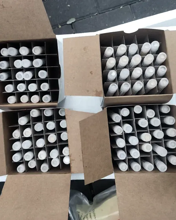 Sample vials boxed in divided racks for export