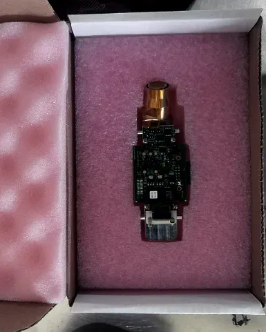 A circuit assembly seated in pink anti-static foam inside its shipping box