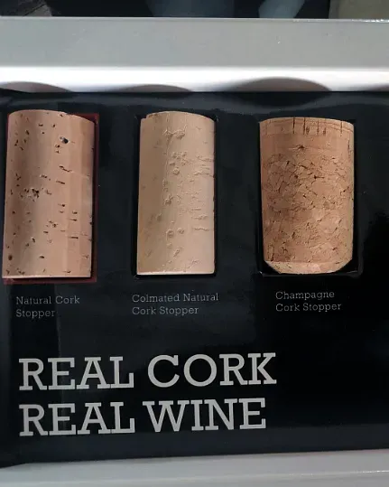 Three cork stoppers mounted and labelled on a black presentation board